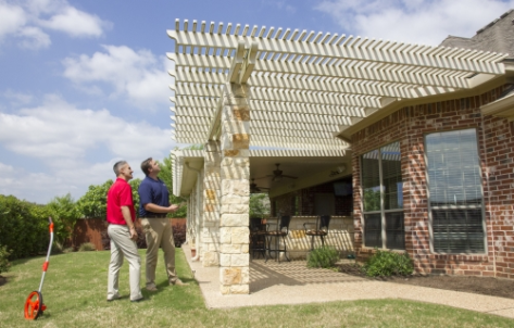 two men inspecting an outdoor patio