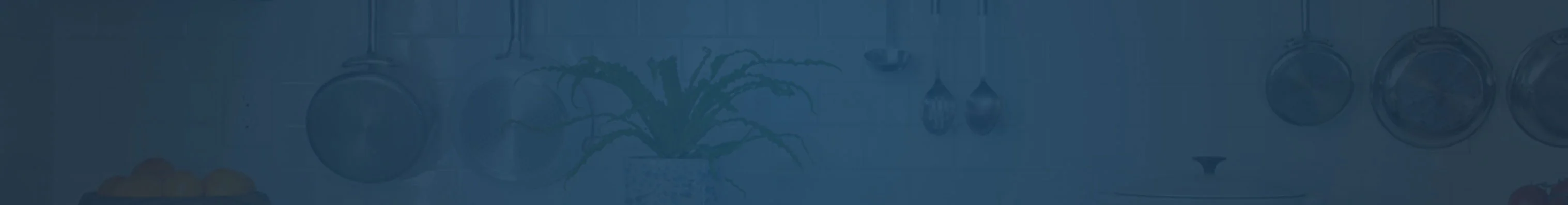 Close-up with transparent blue image overlay of tiled kitchen wall with ladles hanging from utensil rack. 