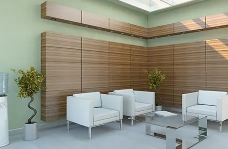 A calming medical office waiting room with light green walls.