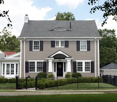 Two-story home with brown, gray, and white exterior paint