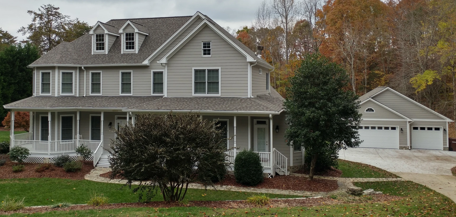 Large gray painted home with two-car garage