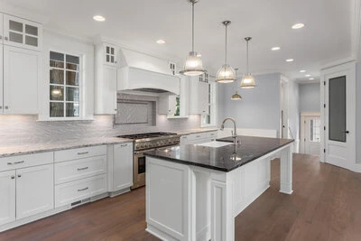 Spacious and modern kitchen with white cabinets and kitchen island.